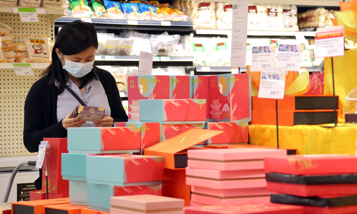 A customer shops for mooncakes in a Chinese chain supermarket in Toronto, Canada on Monday. Photo: cnsphoto
