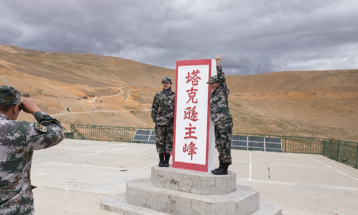 Two soldiers from the art troupe of the PLA Xizang Military Command have their photo taken at a border military post before a performance on Friday. Photo: Shan Jie
