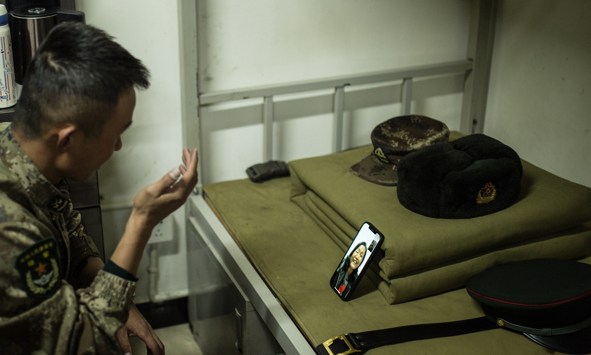 Wan Bo, a squad leader at the third company of the model battalion, is on a video call with his mother after dinner with his brothers in arms to celebrate the Mid-Autumn Festival on Sunday. Photo: Shan Jie
