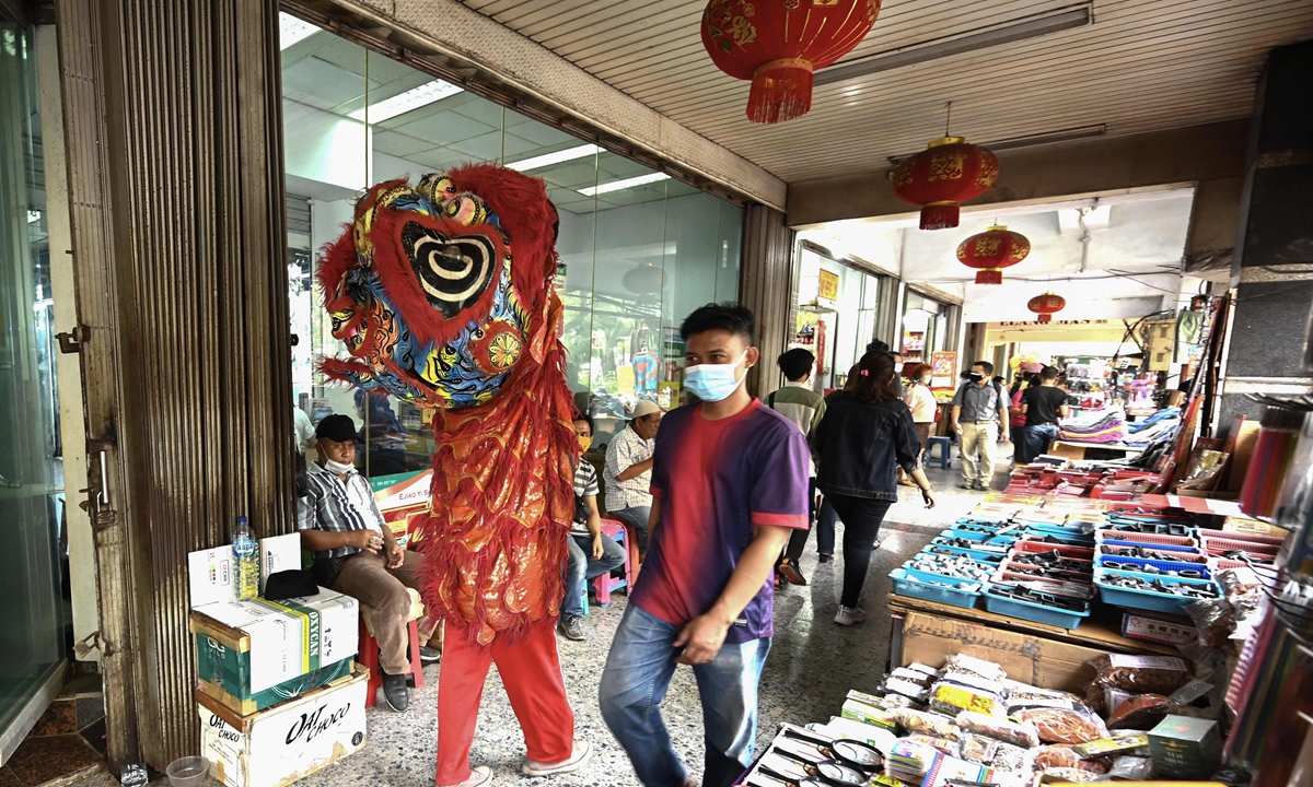 A man in a costume welcomes shoppers to a market in Jakarta's Chinatown on Tuesday, part of Indonesia's celebrations for the Mid-Autumn Festival. Photo: VCG