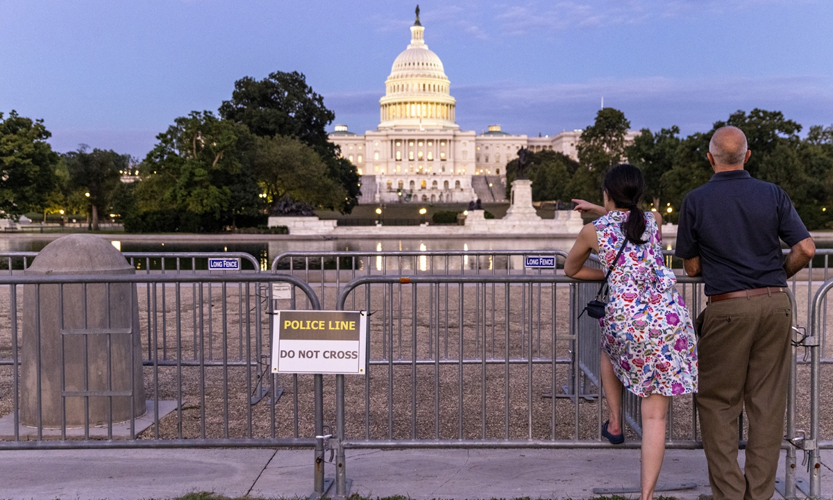 Tourists view the US Capitol behind security fencing on September 17 in Washington DC. Photo: AFP