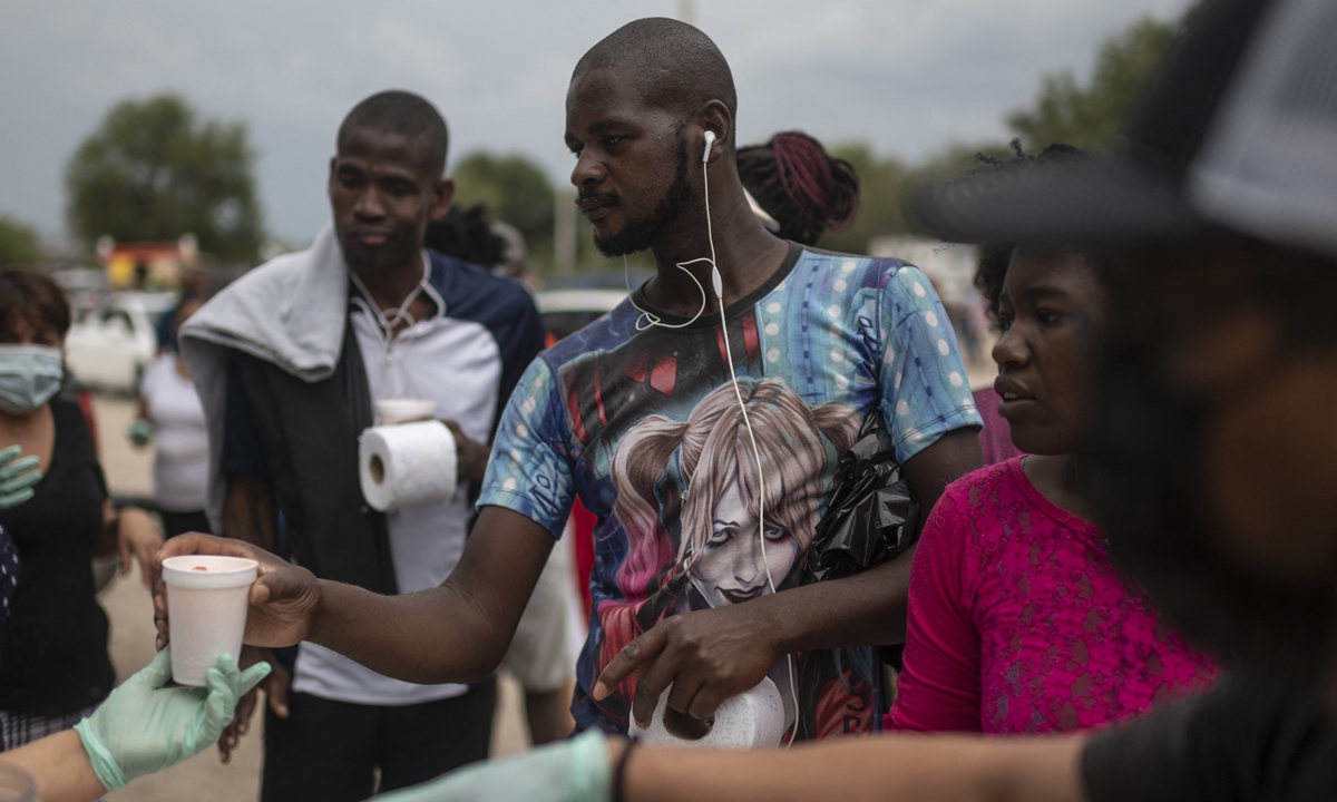 Haitian migrants receive drinks at a shelter in Ciudad Acuna, Coahuila state, Mexico, on Tuesday. Mexico has told the US that it wants a regional agreement to tackle the tide of migrants arriving at the two countries' borders, Foreign Minister Marcelo Ebrard said on Tuesday. Photo: VCG