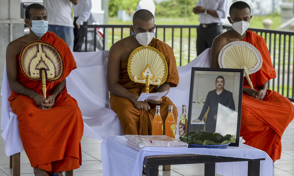 Buddhist monks perform the last rite during the funeral of Eliyantha White, a local shaman who claimed he had super natural powers to end the pandemic and died of COVID-19, at the Colombo General Cemetery in Colombia, Sri Lanka on Thursday. Photo: AFP