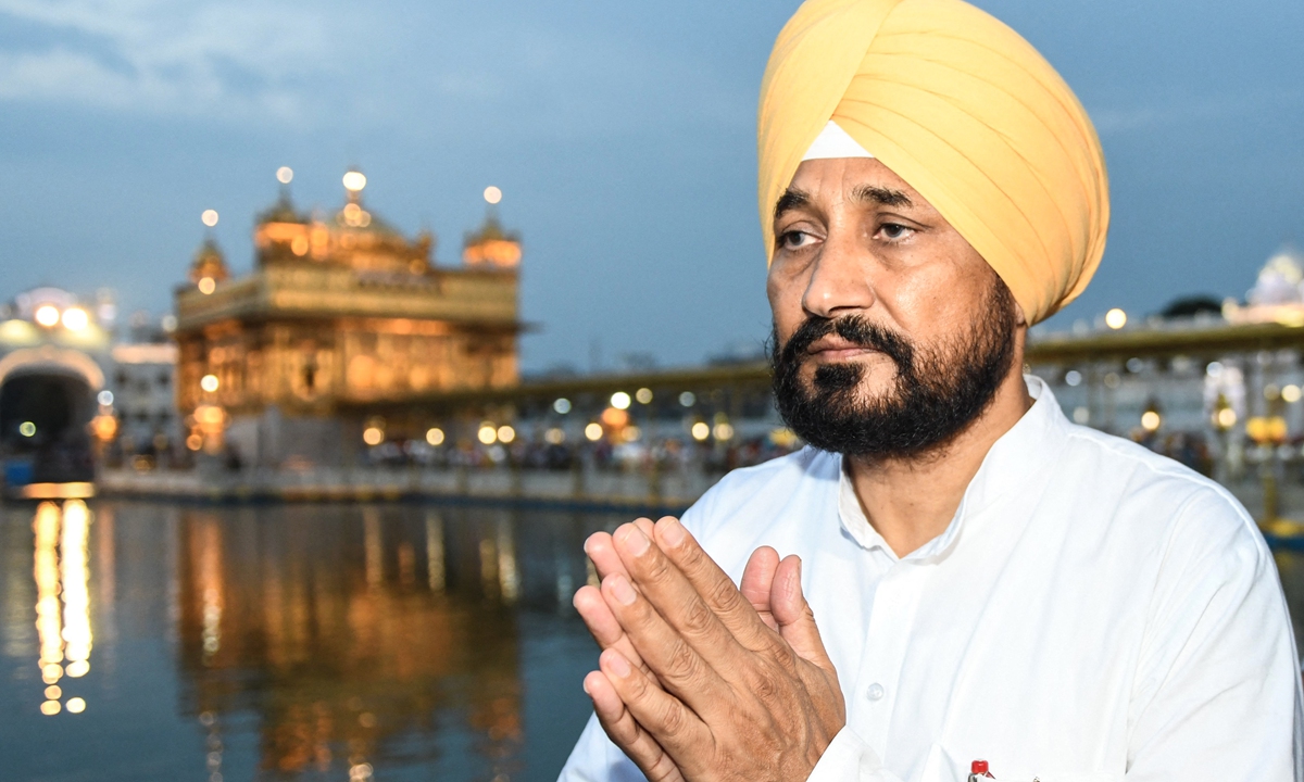 Newly sworn-in Punjab Chief Minister Charanjit Singh Channi 
pays his respects at the Golden Temple in Amritsar, India on Wednesday. Photo: AFP