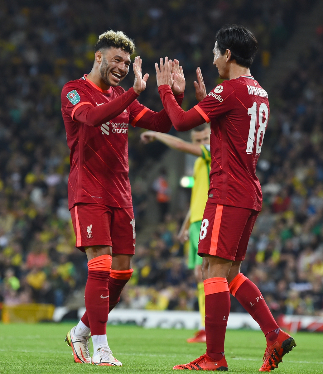 Takumi Minamino (right) of Liverpool celebrates scoring with teammate Alex Oxlade-Chamberlain on Tuesday in Norwich, England. Photo: VCG