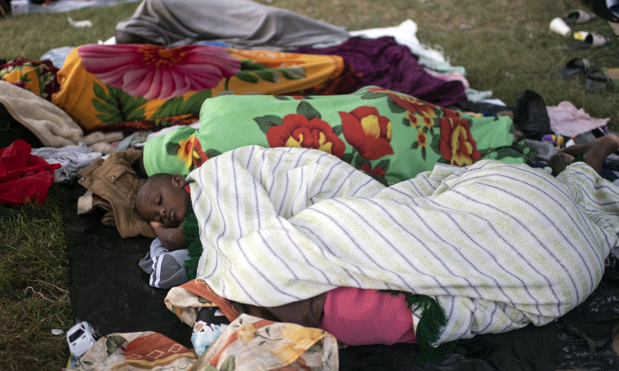 Haitian migrants rest at a shelter in Ciudad Acuna, Coahuila state, Mexico, on Wednesday. Clinging to ropes, some carrying children on their shoulders, Haitian migrants stranded at the US border cross the Rio Grande back into Mexico in search of food, water or medical treatment. Photo: AFP