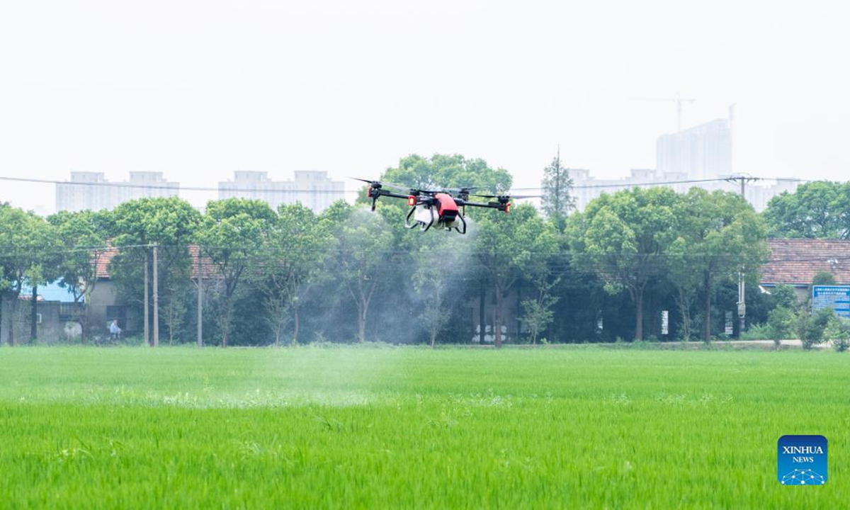 Farmers operate rice harvesters during an demonstration event in celebration of the Chinese farmers' harvest festival at Hongguang Village, Changchun City of northeast China's Jilin Province, Sept. 23, 2021. Thursday marks the Chinese farmers' harvest festival, which is celebrated on the Autumn Equinox. (Xinhua/Zhang Nan)

