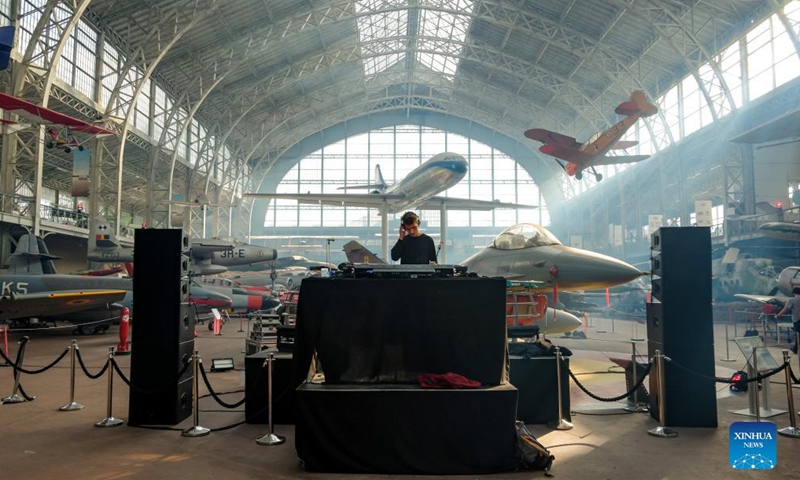 A disc jockey is seen during the IIIMAGINE live electronic music show at the Aviation Hall of the Royal Museum of the Armed Forces and Military History in Brussels, Belgium, on Sep 24, 2021.Photo:Xinhua