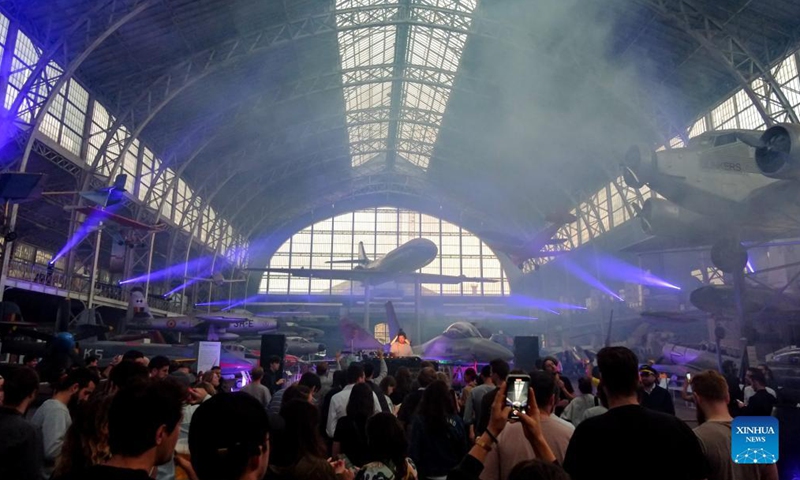 People attend the IIIMAGINE live electronic music show at the Aviation Hall of the Royal Museum of the Armed Forces and Military History in Brussels, Belgium, on Sep 24, 2021.Photo:Xinhua