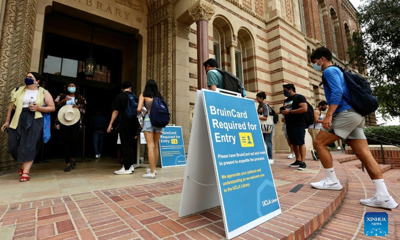Students are seen at the entrance of the Library on campus of the University of California, Los Angeles (UCLA), in Los Angeles, the United States, Sept. 23, 2021.Photo:Xinhua
