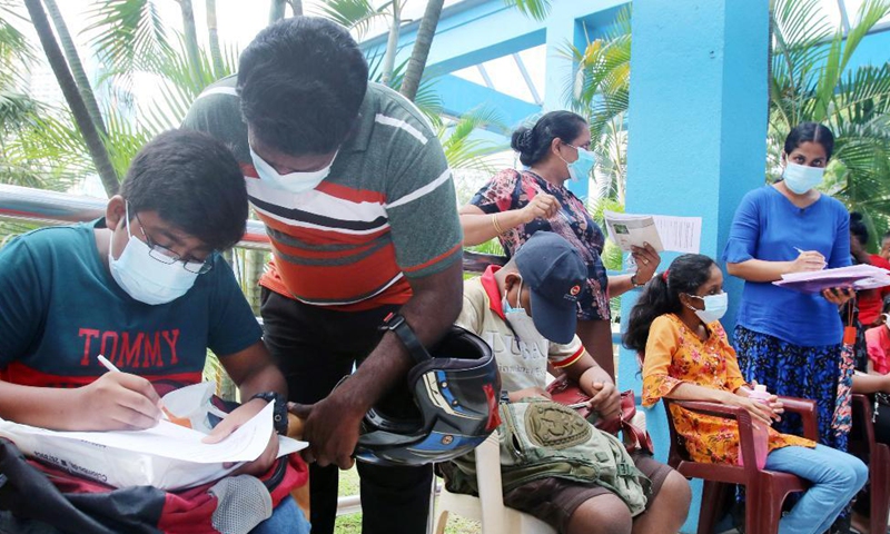 Children and their parents fill in forms for receiving COVID-19 vaccines at a hospital in Colombo, Sri Lanka, Sept. 24, 2021. Sri Lankan authorities on Friday began administering the COVID-19 vaccines to children aged 12 to 19 years who have comorbidities and are disabled.Photo:Xinhua