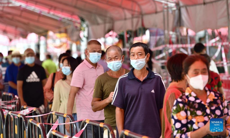Residents wait in line to receive nucleic acid testing outside a testing site at Butang Village in Tongan District of Xiamen City, southeast China's Fujian Province, Sept. 23, 2021. Photo:Xinhua