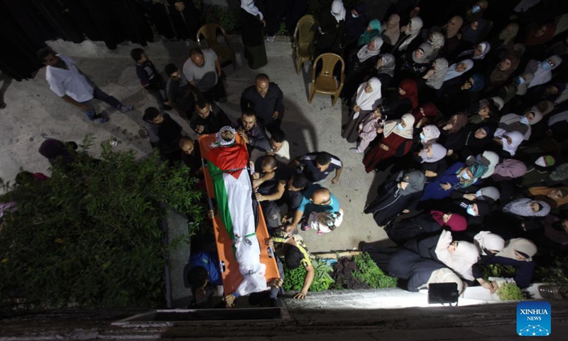 People carry the body of Palestinian man Mohammed Khbeisa during his funeral in the village of Beita, near the northern West Bank city of Nablus, on Sept. 24, 2021.Photo:Xinhua