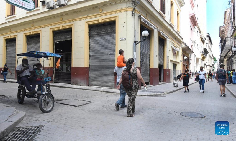People walk on the street amid the COVID-19 pandemic in Havana, Cuba, Oct. 2, 2021. (Photo by Joaquin Hernandez/Xinhua)