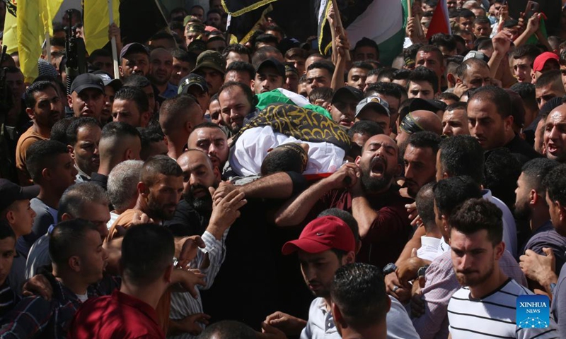 Mourners and relatives carry the body of Palestinian Osama Soboh during his funeral in Burqin village west of the West Bank city of Jenin, on Sept. 26, 2021. Palestine on Sunday condemned Israeli soldiers for killing five Palestinians in two separate incidents in northern West Bank and northwest of Jerusalem.(Photo: Xinhua)