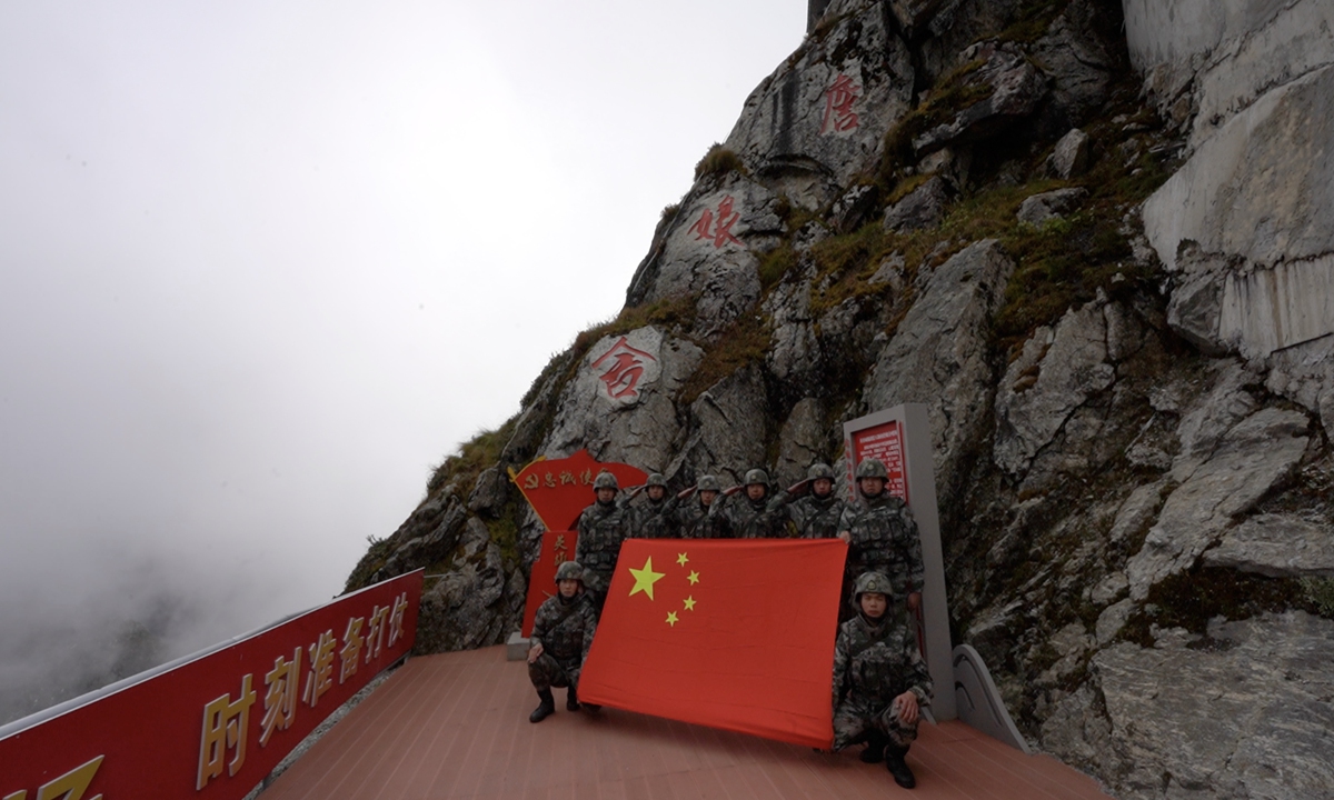 Squad members of the Zhanniangshe post hold a Chinese national flag. Photo: Li Jieyi/GT