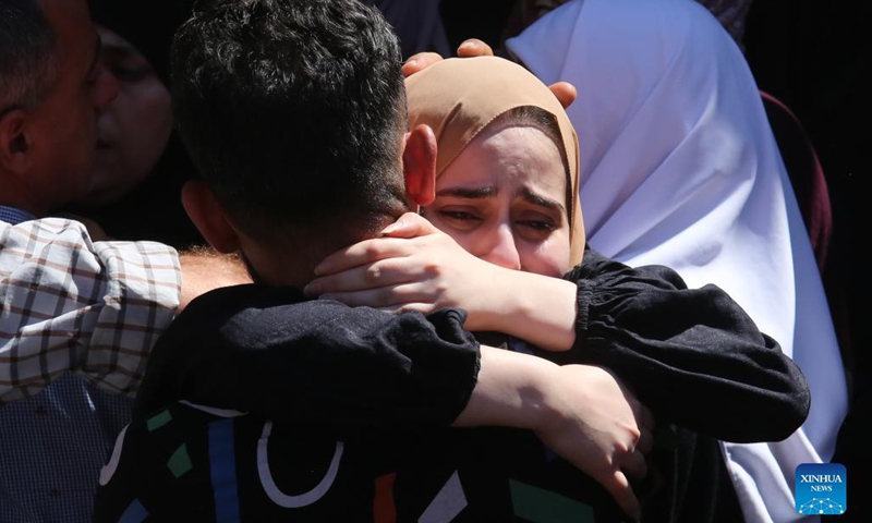 A relative of Palestinian Osama Soboh grieves during his funeral in Burqin village west of the West Bank city of Jenin, on Sept. 26, 2021. Palestine on Sunday condemned Israeli soldiers for killing five Palestinians in two separate incidents in northern West Bank and northwest of Jerusalem.(Photo: Xinhua)