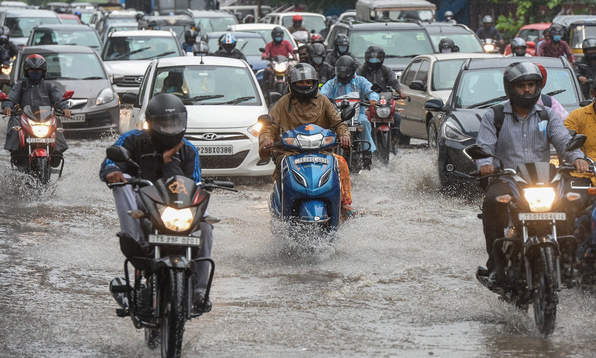 Motorists make their way through a water-logged street amid heavy rains in Hyderabad city, India on Monday, the morning after cyclone Gulab made landfall between the coastal Indian states of Odisha and Andhra Pradesh. Photo: AFP