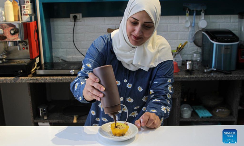 Palestinian woman Marwa Khadra works at her own cafe Station Cafe in Gaza City, on Sept. 27, 2021. As the Gaza Strip has long been under the threat of high unemployment rate, many Palestinian women there have to rely on their own wits to make a living.(Photo: Xinhua)
