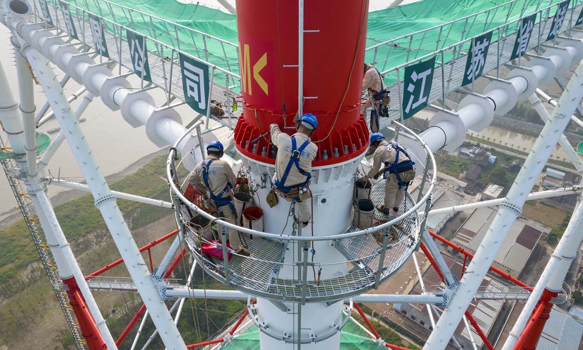 Workers assemble world's tallest transmission tower Global Times
