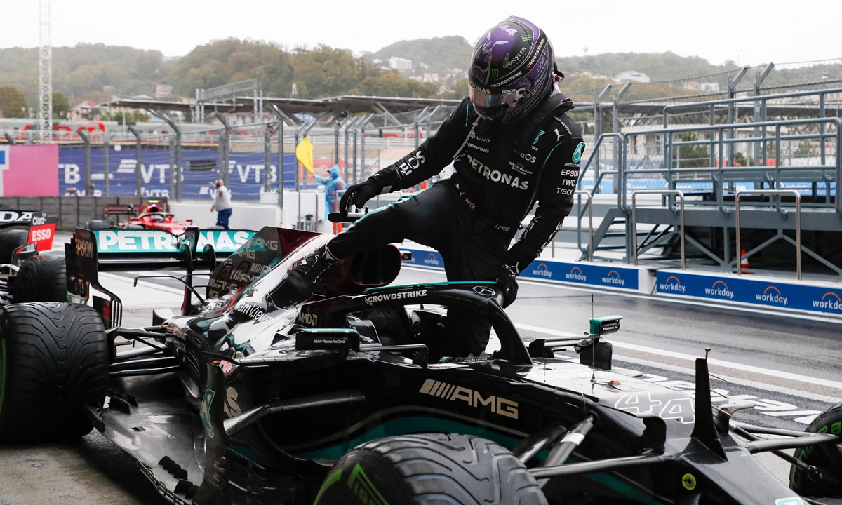 Lewis Hamilton gets out of his car after winning the Formula One Russian Grand Prix in Sochi on Sunday.  Photo: VCG