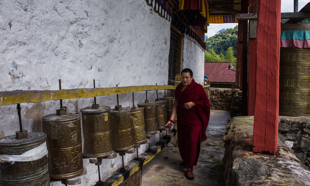 Le maître du monastère Renqinbeng de Medog fait tourner les moulins à prières.  Photo : Shanjie/GT