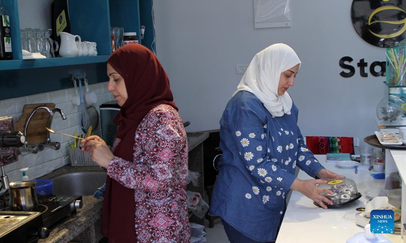 Palestinian sisters Ahlam (L) and Marwa Khadra work at their own cafe Station Cafe in Gaza City, on Sept. 27, 2021. As the Gaza Strip has long been under the threat of high unemployment rate, many Palestinian women there have to rely on their own wits to make a living.(Photo: Xinhua)