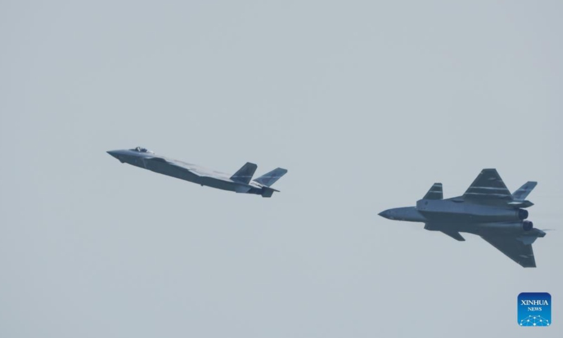 J-20 stealth fighter jets perform aerobatics during the 13th China International Aviation and Aerospace Exhibition, or Airshow China 2021, in Zhuhai, south China's Guangdong Province, Sept. 29, 2021.Photo:Xinhua