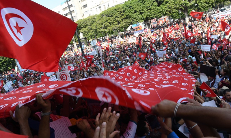 Tunisian people take to the streets, waving national flags and chanting slogans to support their president Kais Saied in Tunis, Tunisia, on Oct. 3, 2021.(Photo: Xinhua)
