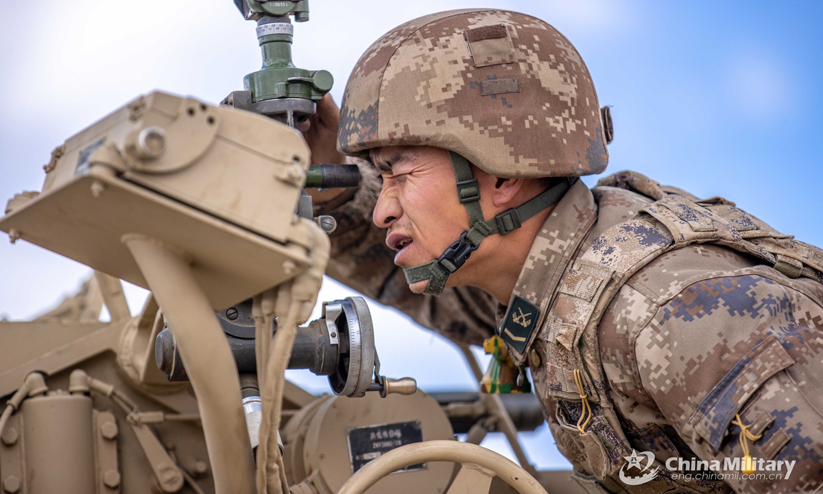 An artilleryman assigned to a combined-arms regiment under the PLA Xinjiang Military Command uses an optical device to take sight and be ready for shelling the targets during a live-fire training exercise in mid September, 2021.Photo:China Military