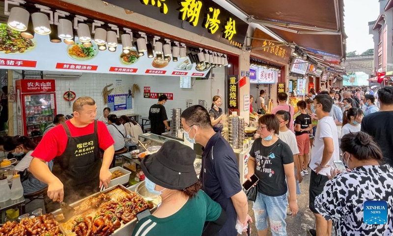 People visit a food street during the week-long National Day holiday in Wuhan, central China's Hubei Province, Oct. 2, 2021.Photo:Xinhua