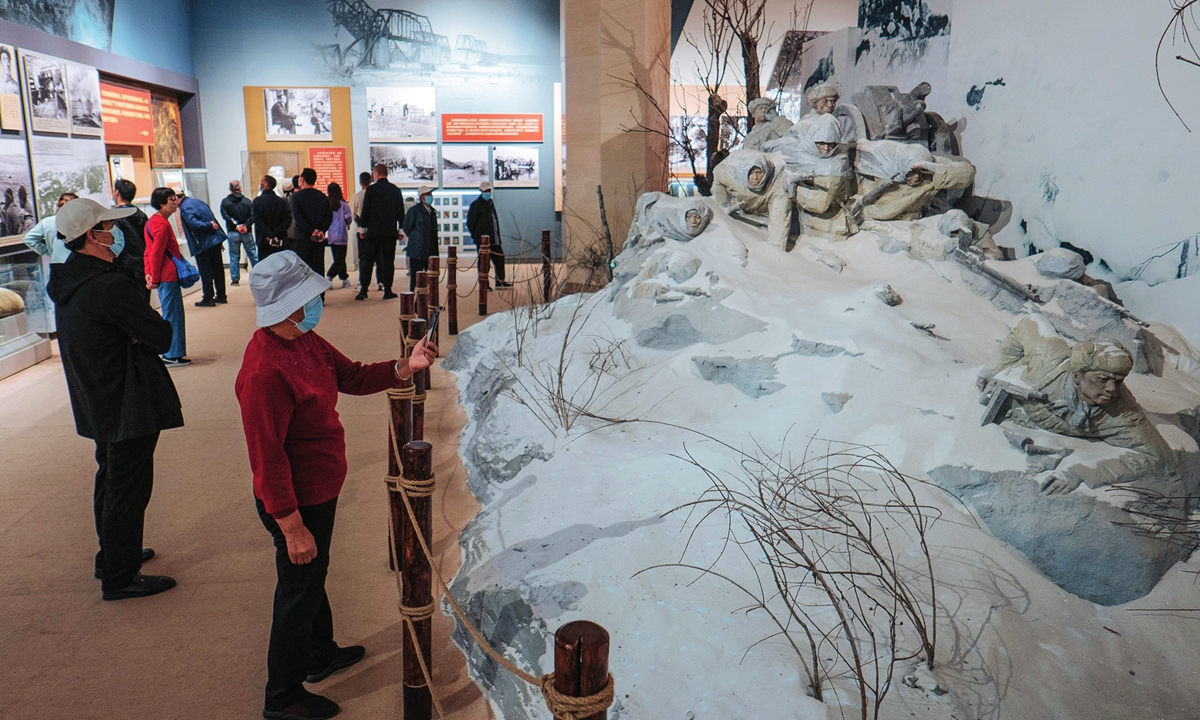A visitor takes a picture of the diorama of the Battle at Lake Changjin, at an exhibit commemorating the 70th anniversary of the battle in the War to Resist US Aggression and Aid Korea (1950-53), at the Military Museum in Beijing on Friday. Photo: Li Hao/GT