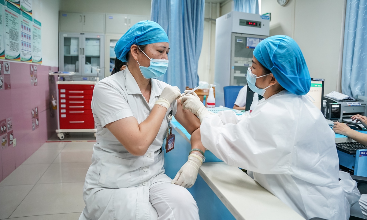 A medical staff member receives a booster shot of a COVID-19 vaccine on Saturday in Nanning, South China's Guangxi Zhuang Autonomous Region. Photo: VCG
