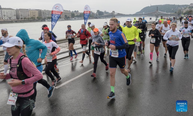 People participate in the Budapest Marathon in downtown Budapest, Hungary on Oct. 10, 2021. (Photo by Attila Volgyi/Xinhua)