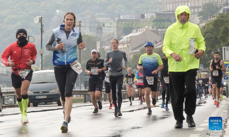 People participate in the Budapest Marathon in downtown Budapest, Hungary on Oct. 10, 2021. (Photo by Attila Volgyi/Xinhua)
