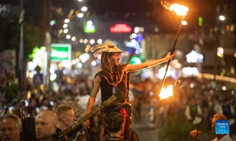 A participant plays with fire sticks during the parade of Ayia Napa Medieval Festival in Ayia Napa, Cyprus, on Oct. 9, 2021.Photo: Xinhua