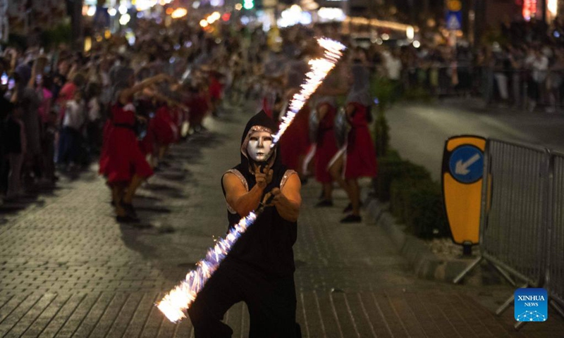 A participant plays with fire sticks during the parade of Ayia Napa Medieval Festival in Ayia Napa, Cyprus, on Oct. 9, 2021.Photo: Xinhua