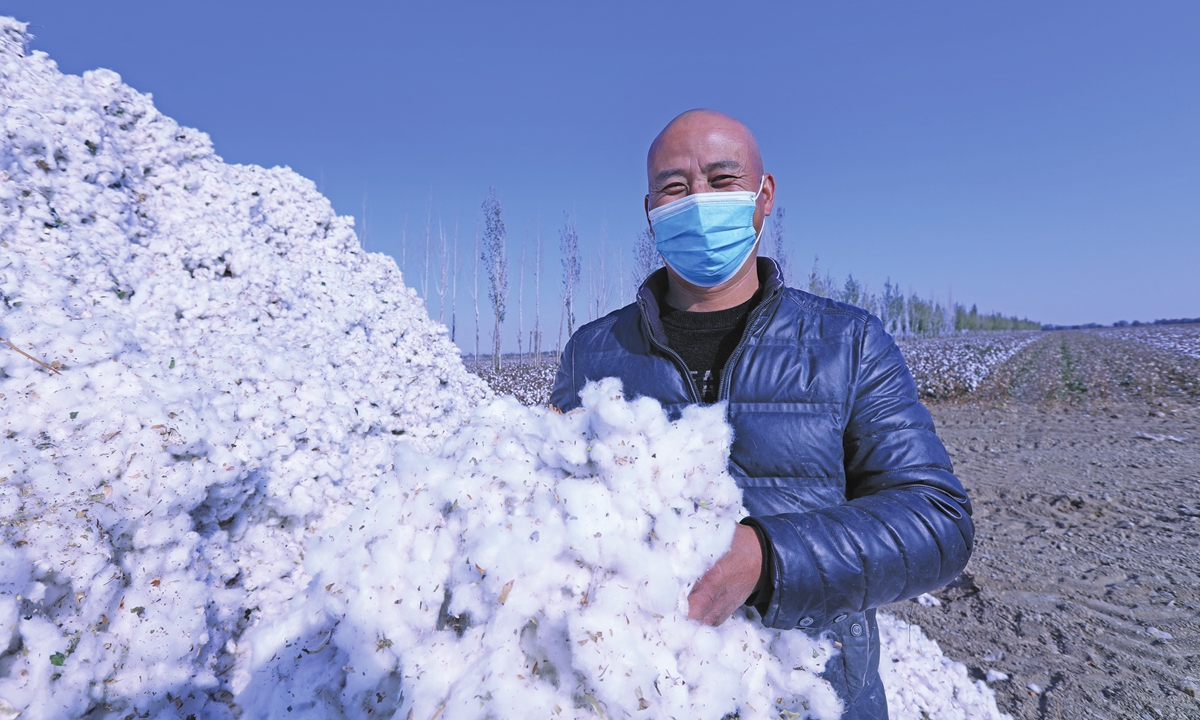 A farmer shows newly-picked cotton in Shuanghe city, Bortala on Saturday.Photo: IC