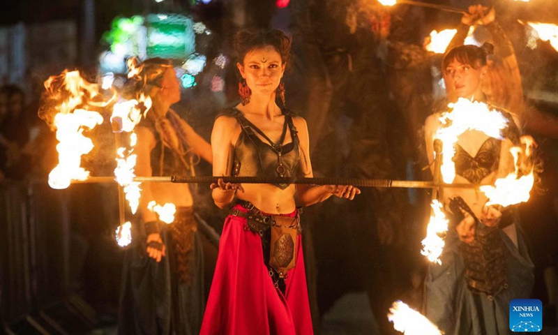 A participant plays with fire sticks during the parade of Ayia Napa Medieval Festival in Ayia Napa, Cyprus, on Oct. 9, 2021.Photo: Xinhua