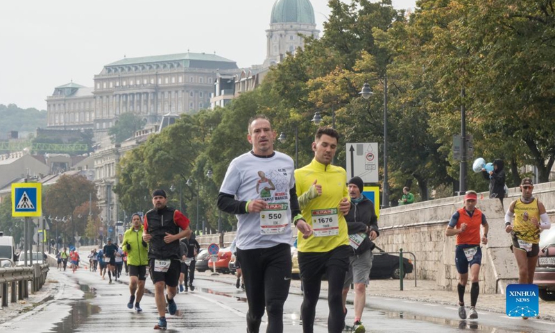 People participate in the Budapest Marathon in downtown Budapest, Hungary on Oct. 10, 2021. (Photo by Attila Volgyi/Xinhua)