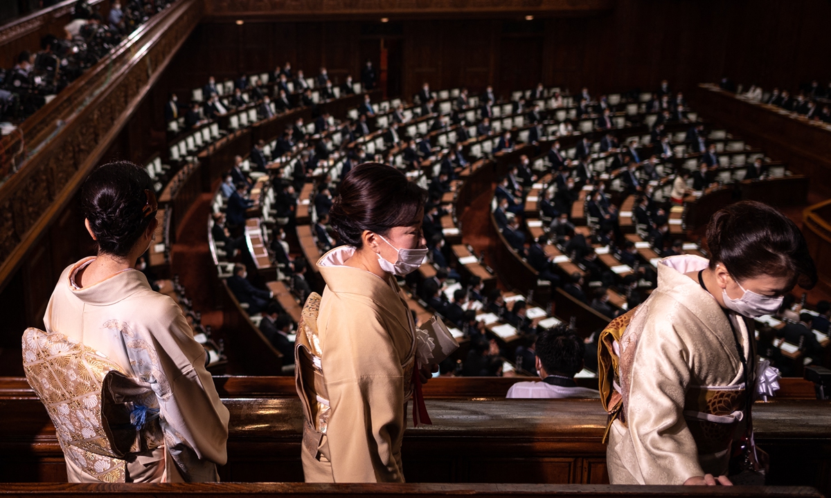 Women in traditional outfits visit before Japan's Prime Minister Fumio Kishida takes part in a question and answer session at the lower house of parliament in Tokyo, Japan on Monday. Photo: AFP