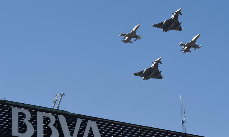 Aircrafts fly at a parade to celebrate the National Day of Spain in Madrid, Spain, Oct. 12, 2021. (Photo by Gustavo Valiente/Xinhua)