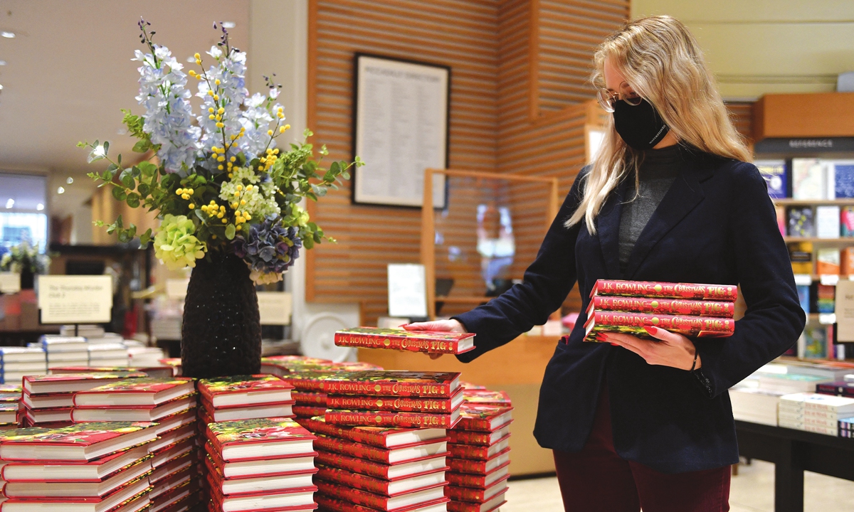 An employee prepares a special display for JK Rowling's new children's novel <em>The Christmas Pig</em> at the Waterstones Piccadilly bookshop in London on Tuesday. Photo: AFP