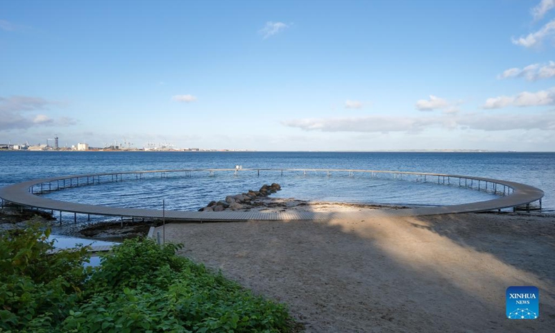 Photo taken on Oct. 11, 2021 shows The Infinite Bridge in Aarhus, Denmark. The Infinite Bridge is a sculpture by Danish architect studio Gjode & Povlsgaard Arkitekter built at the beach in Aarhus. It has a diameter of 60 meters and is positioned half on the beach and half in the sea.(Photo: Xinhua)