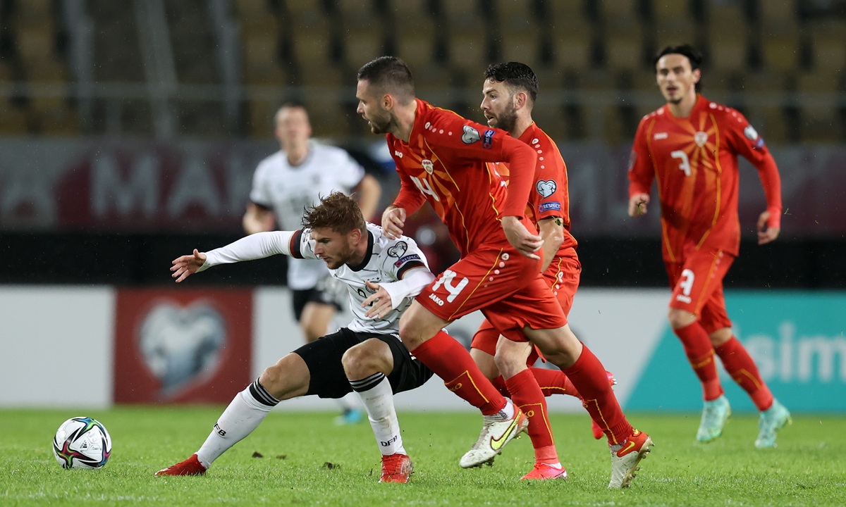 Timo Werner (left) of Germany and Darko Velkoski of North Macedonia battle for the ball on Monday in Skopje, North Macedonia. Photo: VCG