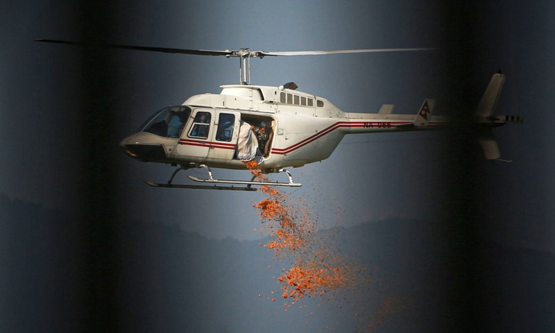 A Nepalese army helicopter showers flower on Fulpati, the seventh day of the Dashain festival, during the biggest Hindu festival Dashain in Kathmandu, Nepal on Oct. 12, 2021(Photo: Xinhua)