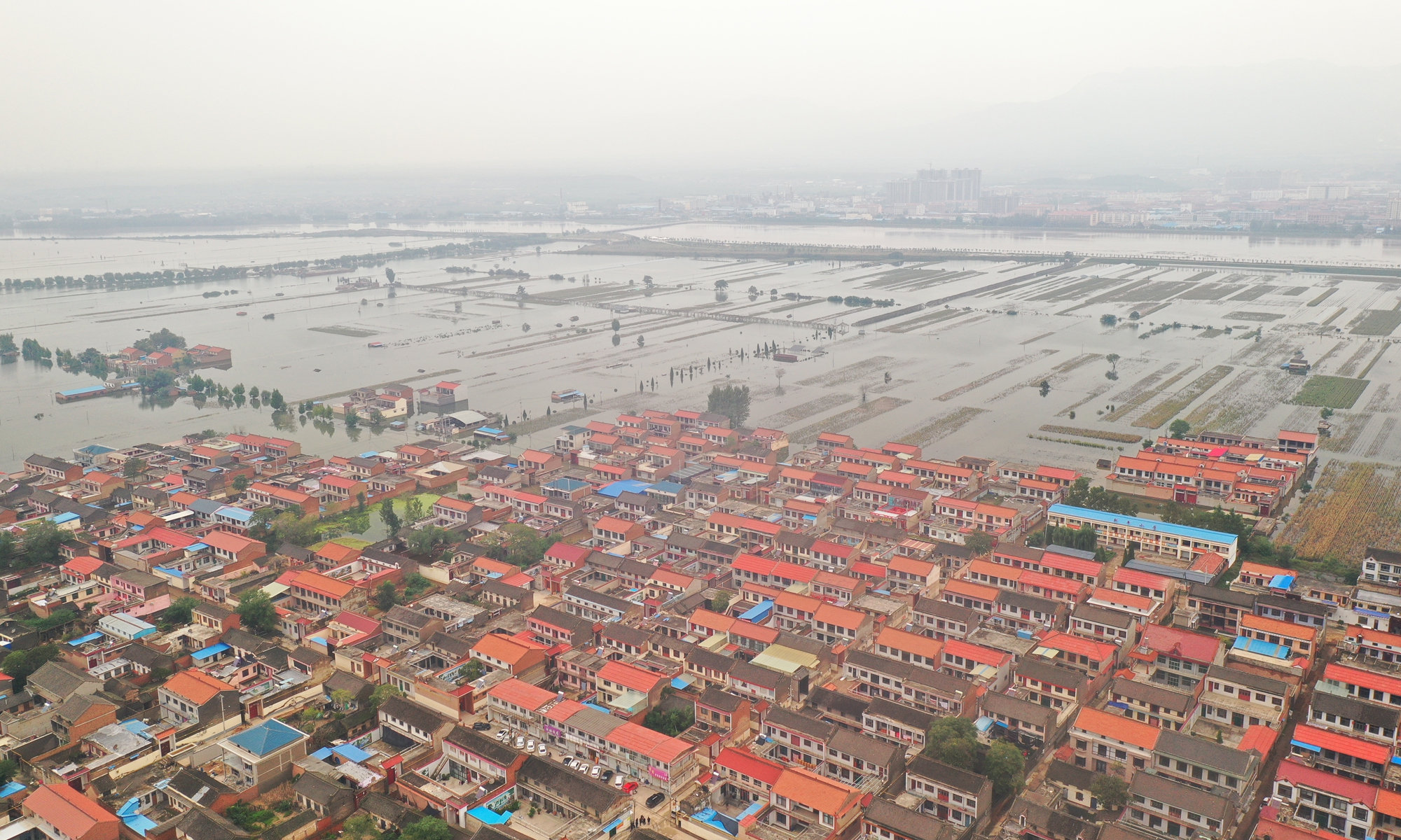 An aerial photo shows houses are soaked in flood water in the worst-hit village Jingping in Jishan county, North China's Shanxi Province. Photo: VCG