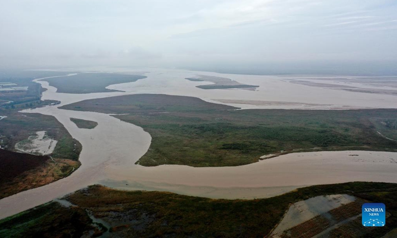 Aerial photo taken on Oct. 14, 2021 shows the confluence of the Yellow River and Fenhe River in Miaoqian Village of Wanrong County, Yuncheng, north China's Shanxi Province. The water level of Hejin section of the Fenhe River in Yuncheng has dropped to 376.39 meters. (Xinhua/Zhan Yan)