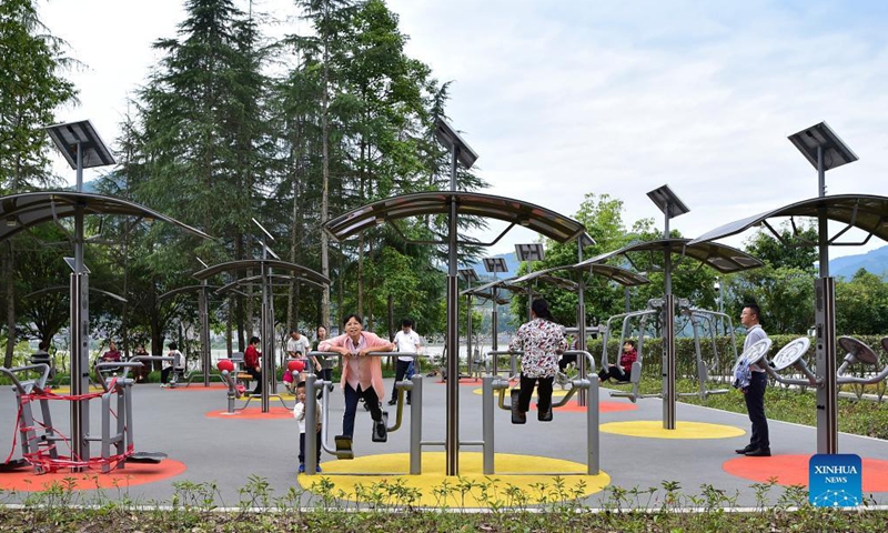 People exercise at a waterside park in southwest China's Chongqing, Oct. 13, 2021. A 33km waterside walkway, which links six areas and eight parks in different themes along two rivers, was built in Yunyang district of Chongqing, providing residents a nice place to spend their leisure time. (Xinhua/Wang Quanchao)

