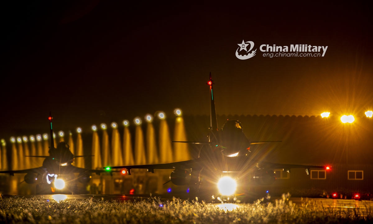 Two fighter jets attached to an aviation brigade of the air force under the PLA Southern Theater Command taxi onto the runway during a midnight flight training exercise on September 26, 2021. (eng.chinamil.com.cn/Photo by Wang Guoyun)